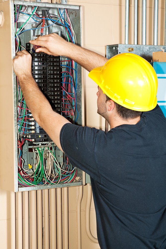 Electrician Inspecting Breaker Box for Electrical Service and Panel Upgrades in Fort Lauderdale