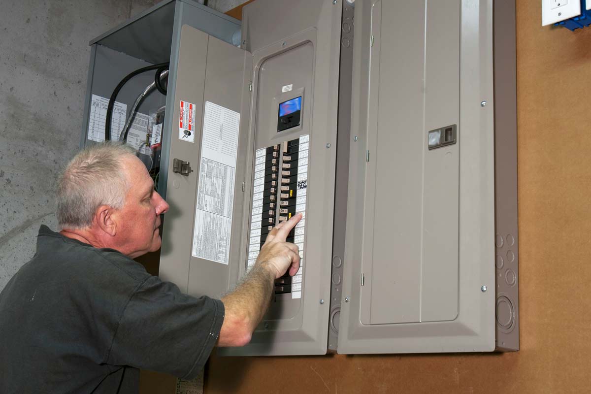 Electrician Inspecting Breaker Box for Fuse Box Upgrades in Weston