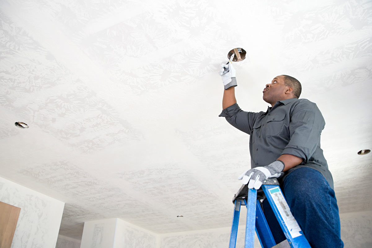 Master electrician at work on a light fixture in Miramar 