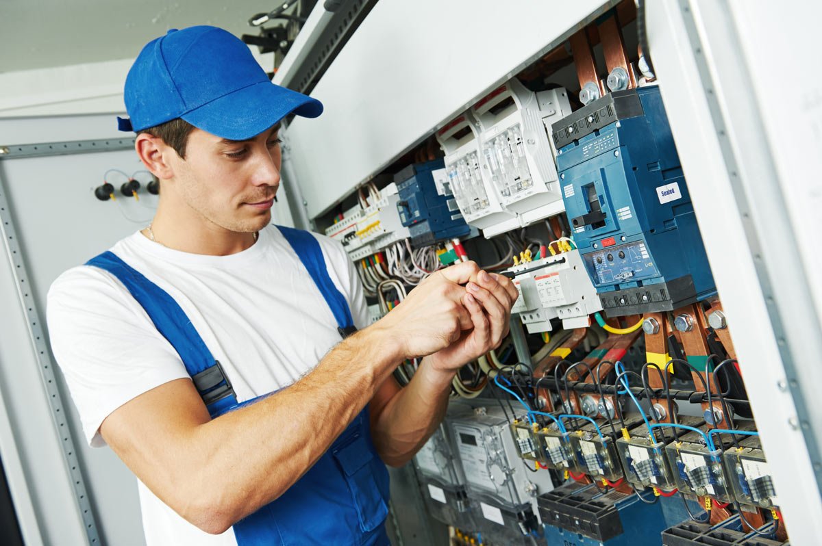 Electrician Working on Breaker Box for Electrical Facility Management in Cooper City