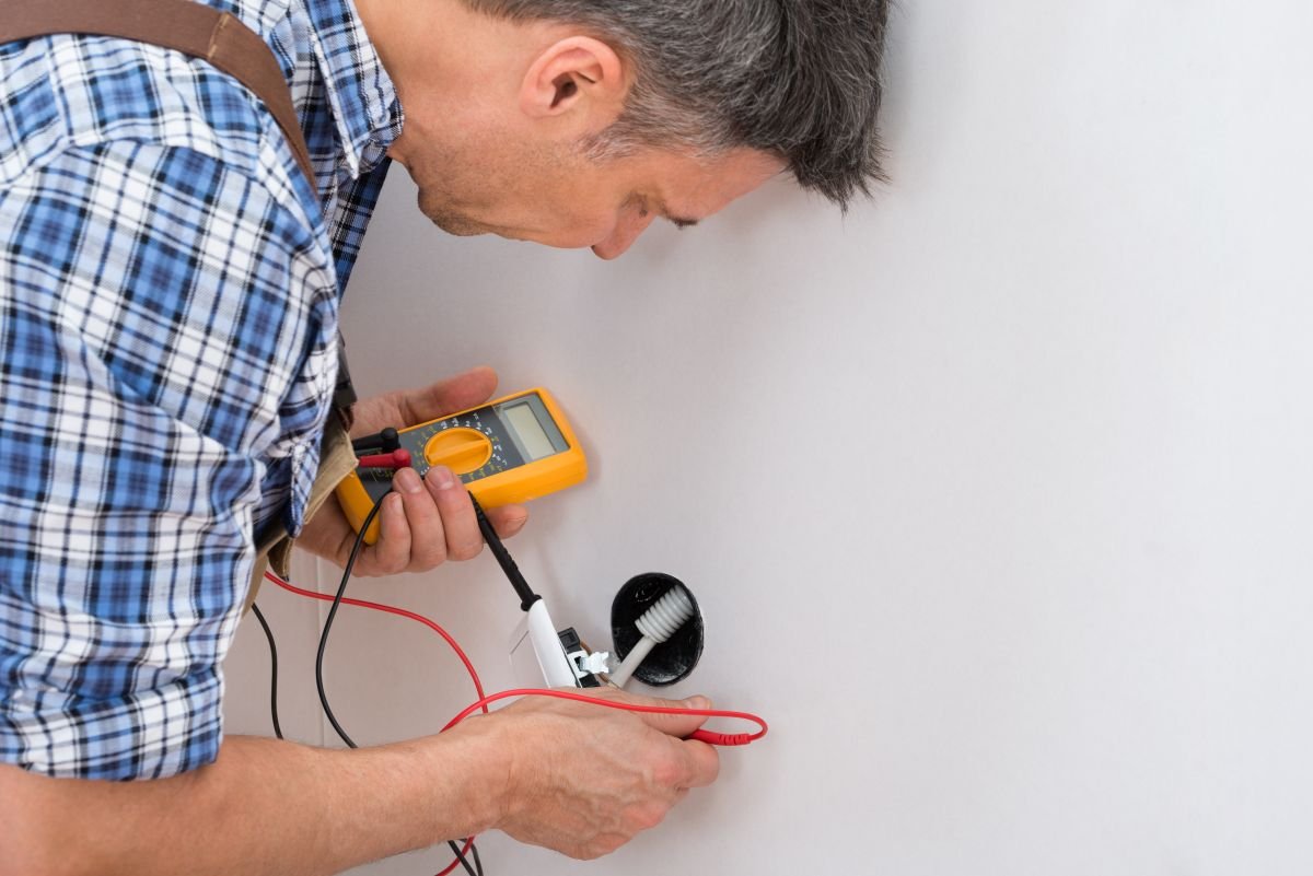 Licensed Electrician testing an outlet in Plantation, FL