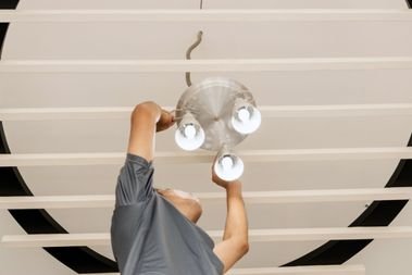 Licensed Electrician installing a light in Cooper City, FL