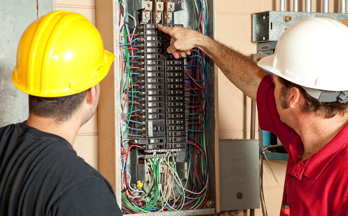 Electricians Inspecting Breaker Box for Fuse Box Upgrades in Weston