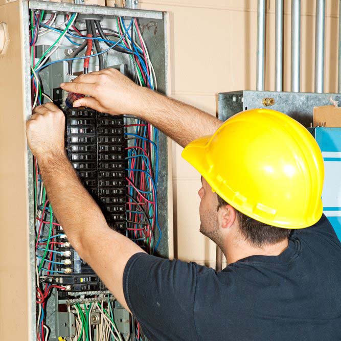 Electrician Performing Electrical Repairs on Breaker Box in Weston