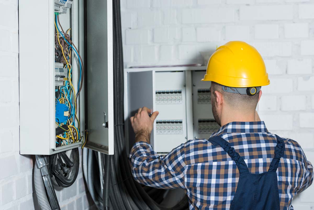 Electrician Inspecting Breaker Box for Generator Home Hook Up in Fort Lauderdale