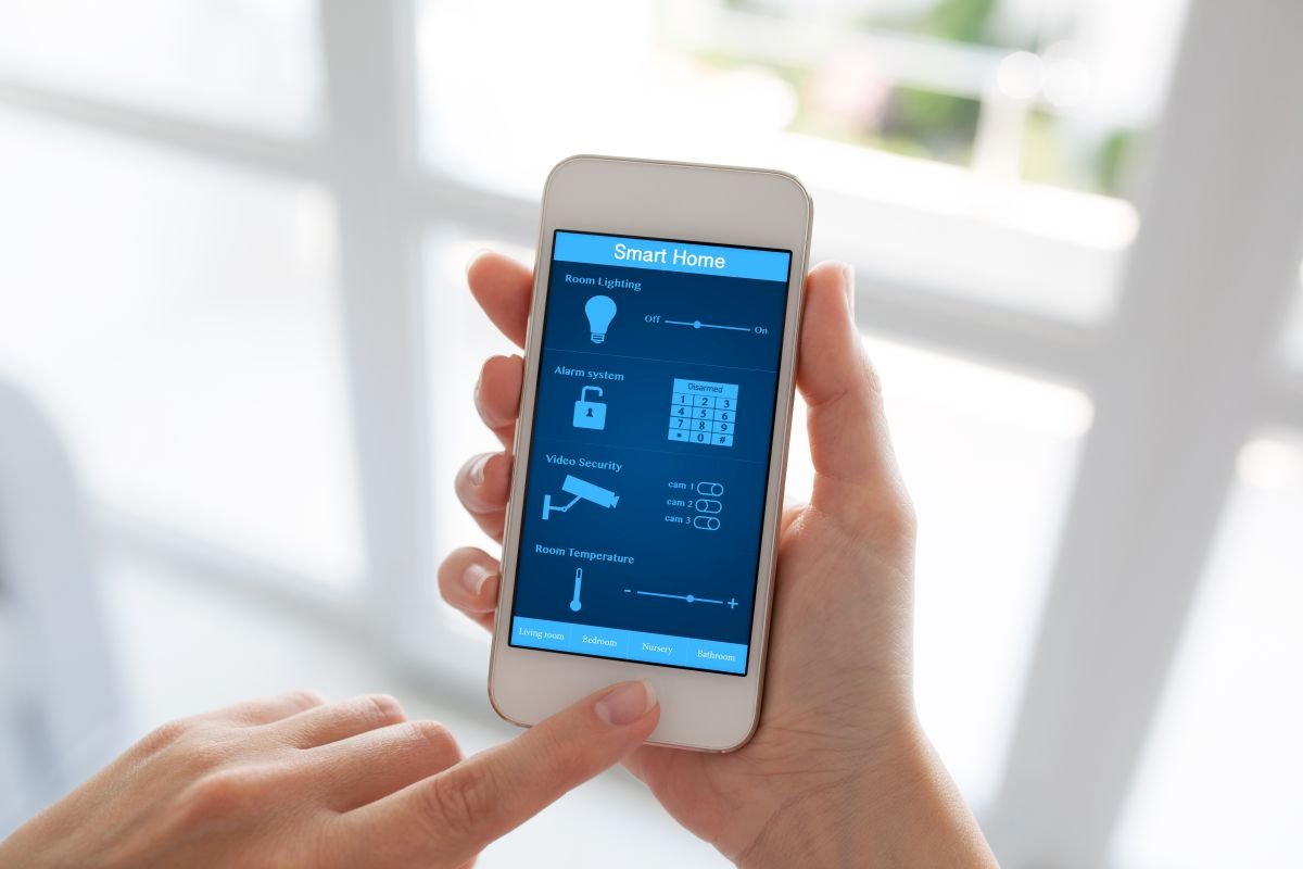 Hands Holding Cellphone with Smart Home Installation Services in Pembroke Pines