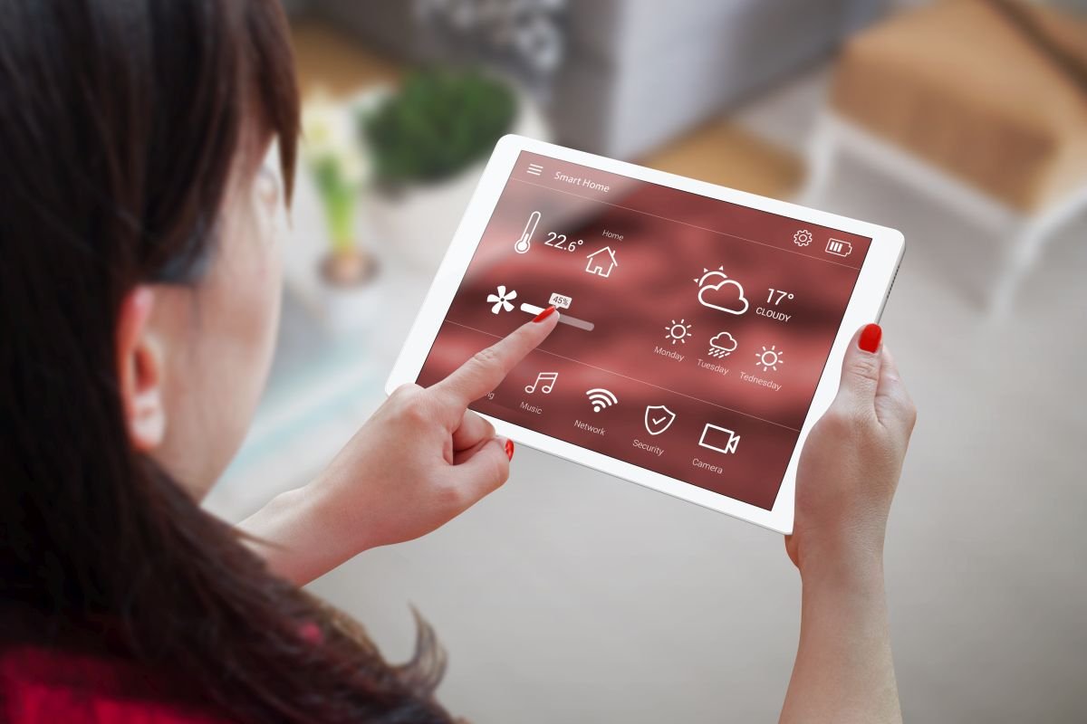 Woman Holding Tablet with Smart Home Installation Services in Weston