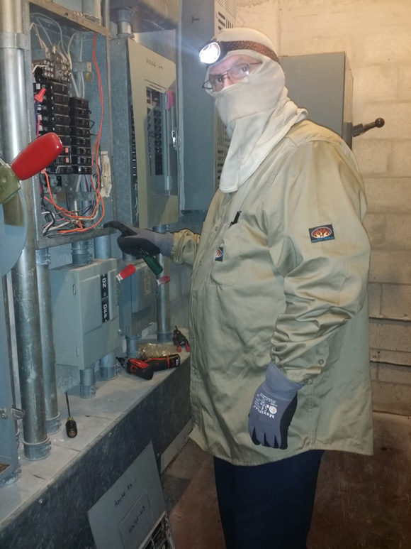 Electrician Inspecting Breaker Box for Preventative Maintenance in Cooper City