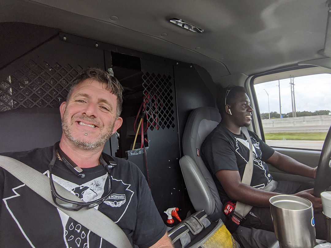 Mark Arruda and employee in truck for Commercial electrician services in Broward County