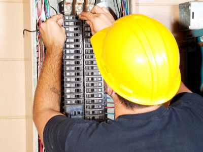 An Electrician in Parkland, FL Performing a Circuit Breaker Repair